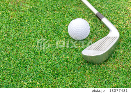 golf ball on tee in front of driver green course 18077481