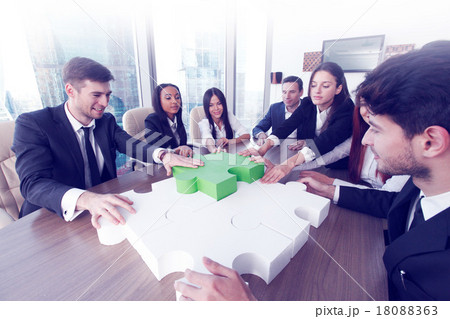 Business people assembling puzzle Business people assembling puzzle 18088363