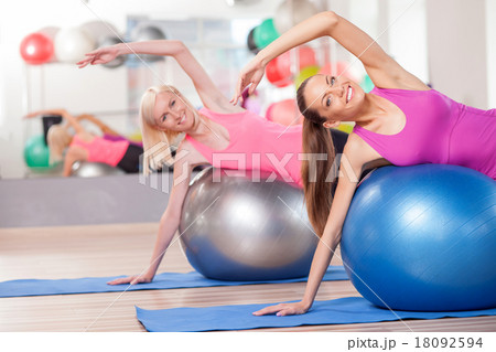 Attractive young women are exercising in gym 18092594