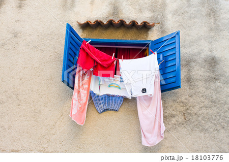 laundry hanging out on a clothesline in the street 18103776