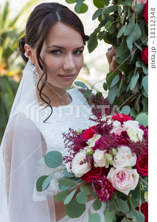 Beautiful bride outdoors with a bouquet Beautiful bride outdoors with a bouquet 18112348