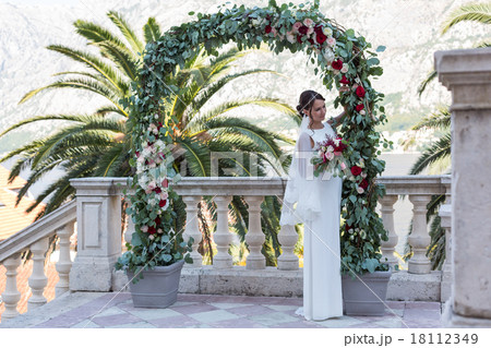Beautiful bride outdoors with a bouquet 18112349