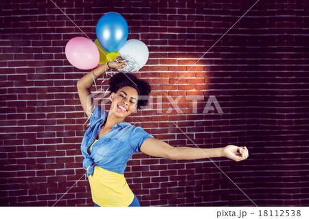 Young woman dancing with balloons Young woman dancing with balloons 18112538