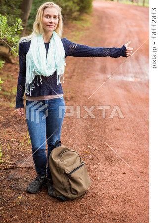 Pretty hitchhiker sticking thumb out Pretty hitchhiker sticking thumb out 18112813