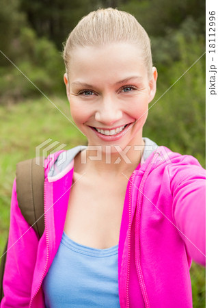 Smiling female hiker taking a selfie 18112996