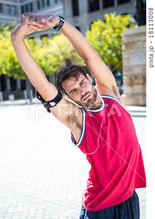 Handsome athlete doing arms stretching 18113008