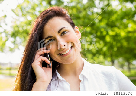 Beautiful brunette in the park making a call 18113370