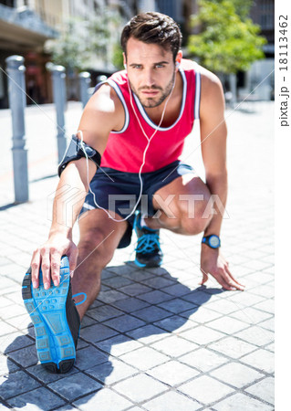 Handsome athlete doing leg stretching 18113462