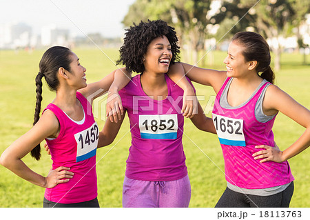 Three laughing runners supporting breast cancer marathon Three laughing runners supporting breast cancer marathon 18113763