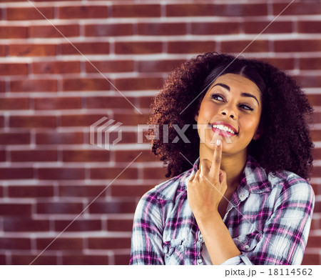 Attractive young woman smiling and daydreaming 18114562