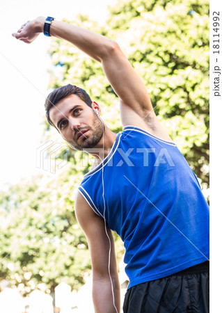 Handsome athlete stretching Handsome athlete stretching 18114992