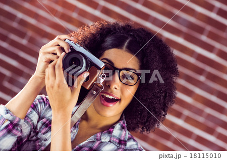 Attractive hipster photographing with camera 18115010