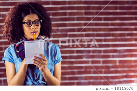 Daydreaming attractive hipster taking notes 18115076