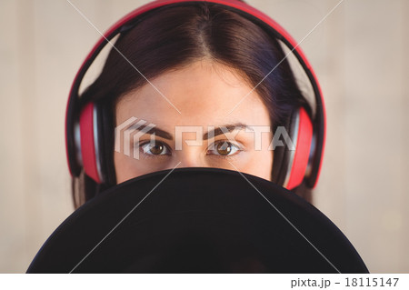 Pretty hipster listening to music holding vinyl Pretty hipster listening to music holding vinyl 18115147