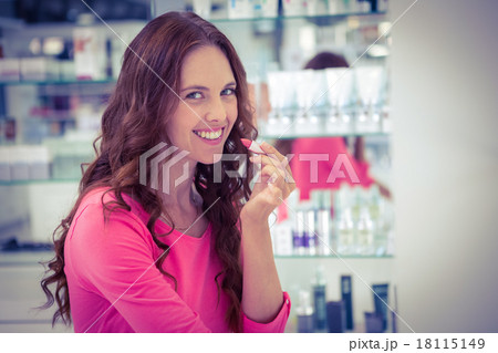 Pretty woman trying a lipstick Pretty woman trying a lipstick 18115149