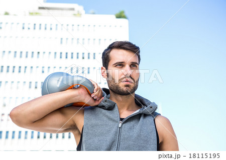 Handsome athlete holding kettle bell Handsome athlete holding kettle bell 18115195