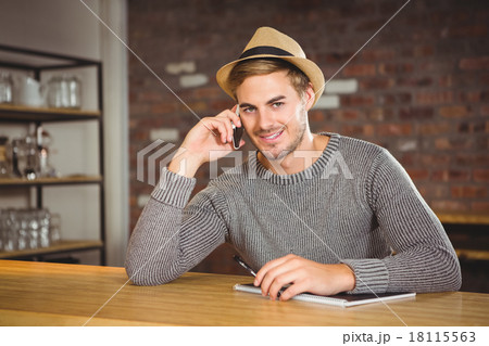 Handsome hipster phoning and holding pen Handsome hipster phoning and holding pen 18115563