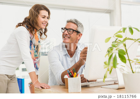 Two casual designers working with computer 18115766