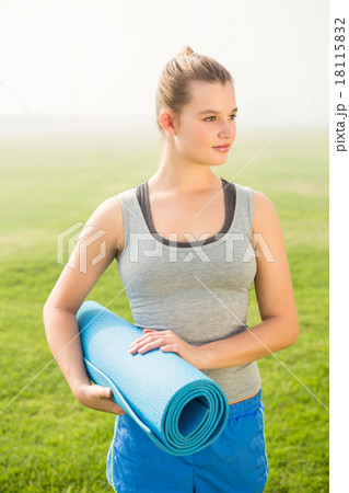 Sporty blonde holding exercise mat Sporty blonde holding exercise mat 18115832