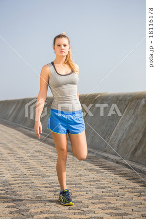 Sporty blonde stretching leg at promenade Sporty blonde stretching leg at promenade 18116178