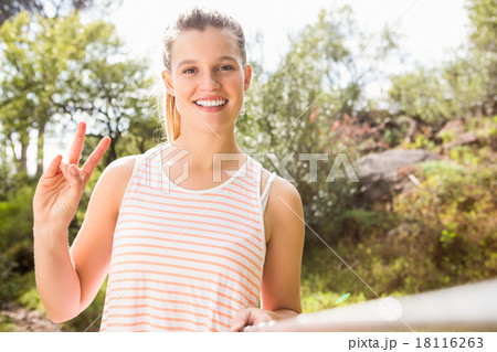 Pretty blonde showing peace sign and taking selfies 18116263