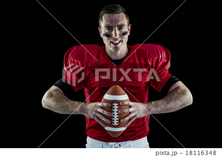 American football player holding a ball 18116348
