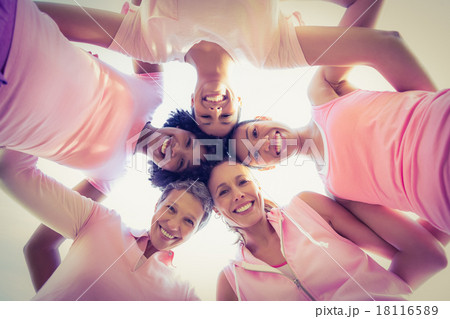 Women wearing pink for breast cancer with arms around 18116589