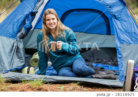 Portrait of a young pretty hiker lying in a tent 18116925