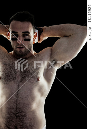 Shirtless American football player with ball 18116926