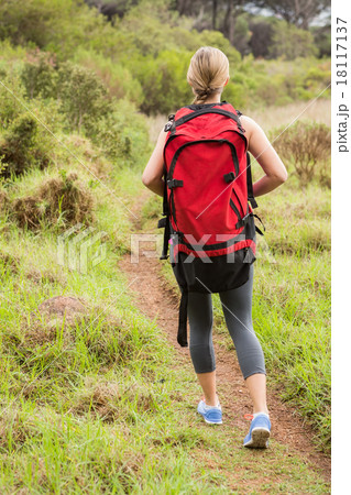 Blonde hiker hiking with backpack 18117137
