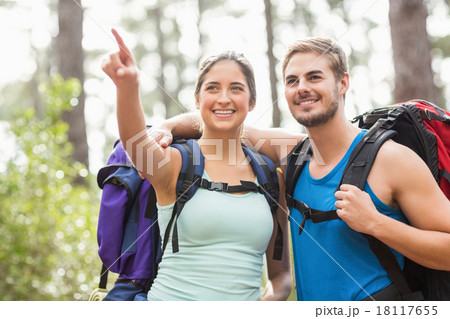 Happy joggers looking away while pointing Happy joggers looking away while pointing 18117655
