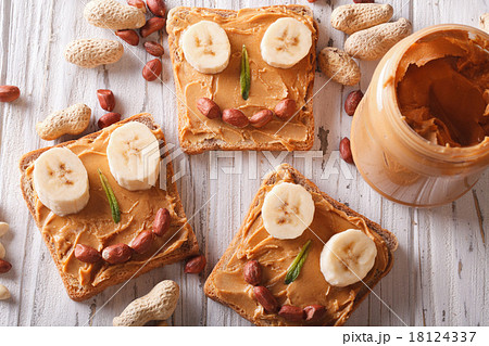 Sandwiches with peanut butter and banana top view Sandwiches with peanut butter and banana top view 18124337