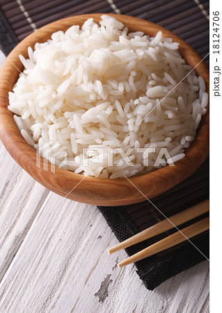 rice in a wooden bowl closeup. vertical rice in a wooden bowl closeup. vertical 18124706