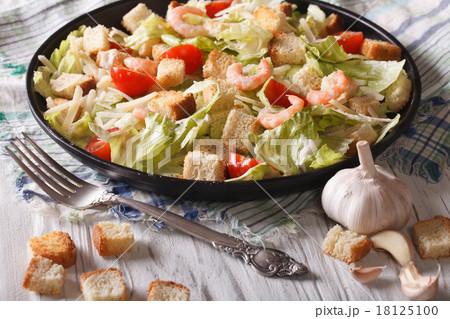 Caesar salad with shrimp and tomatoes closeup Caesar salad with shrimp and tomatoes closeup 18125100
