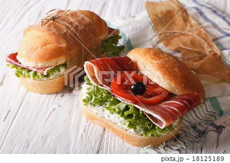 Sandwiches with jamon, soft cheese and vegetables 18125189