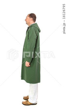 Man in rain green long coat. 18126795