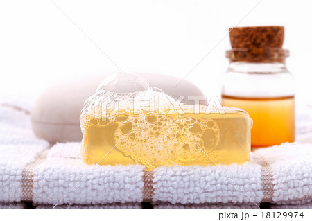 Herbal spa soap bar on white bath towel . Herbal spa soap bar on white bath towel . 18129974