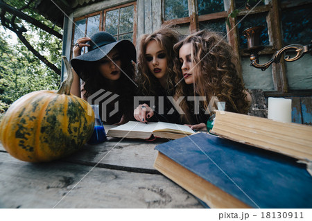 Three vintage witches perform magic ritual 18130911