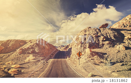 Old film retro stylized rocky desert road, USA. 18131862
