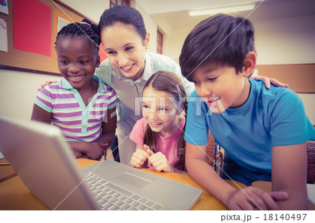 Teacher using laptop with pupils Teacher using laptop with pupils 18140497