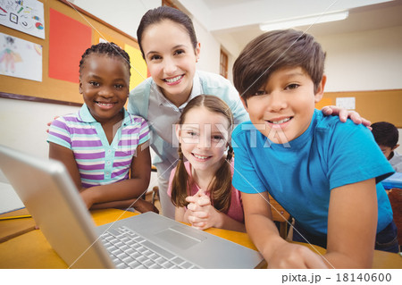 Teacher using laptop with pupils Teacher using laptop with pupils 18140600