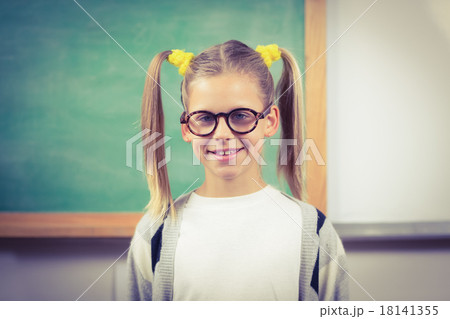 Cute pupil standing in front of chalkboard 18141355