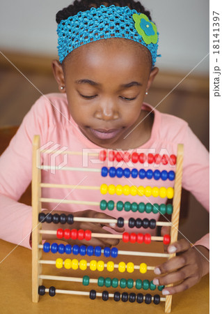 Focused pupil calculating with abacus in a classroom Focused pupil calculating with abacus in a classroom 18141397