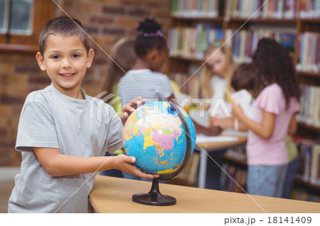 Pupil in library with globe Pupil in library with globe 18141409