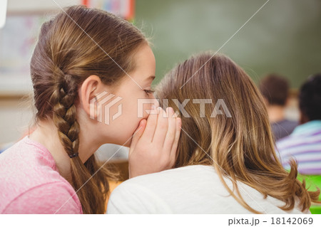 Pupils whispering secrets during class Pupils whispering secrets during class 18142069