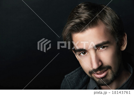 Young handsome man in coat on black background 18143761