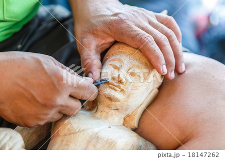 Hand of carver carving wood 18147262