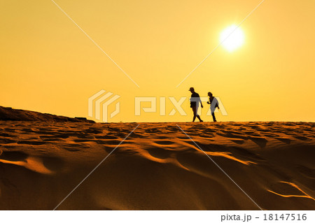 A man walking on sand desert 18147516