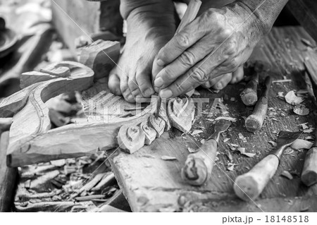 Hand of carver carving wood in black and white color tone 18148518