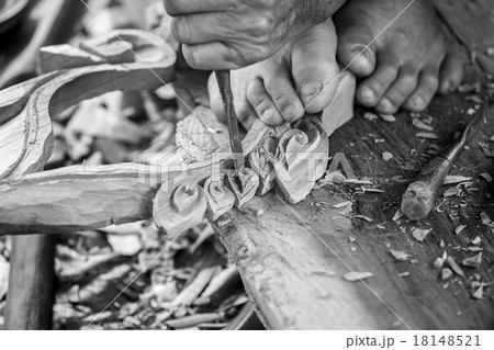 Hand of carver carving wood in black and white color tone 18148521